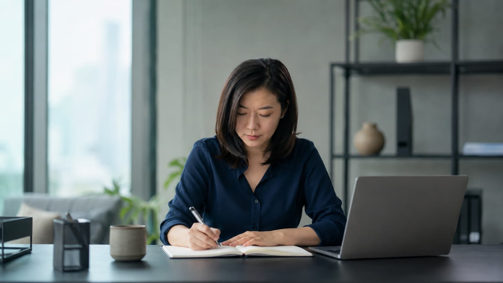 A business owner reviewing financing repayment figures on a laptop