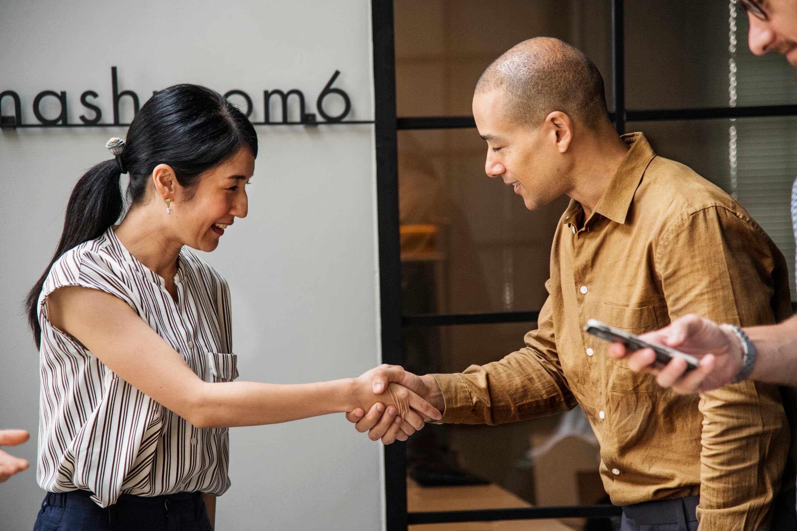 business-people-shaking-hands-agreement-scaled