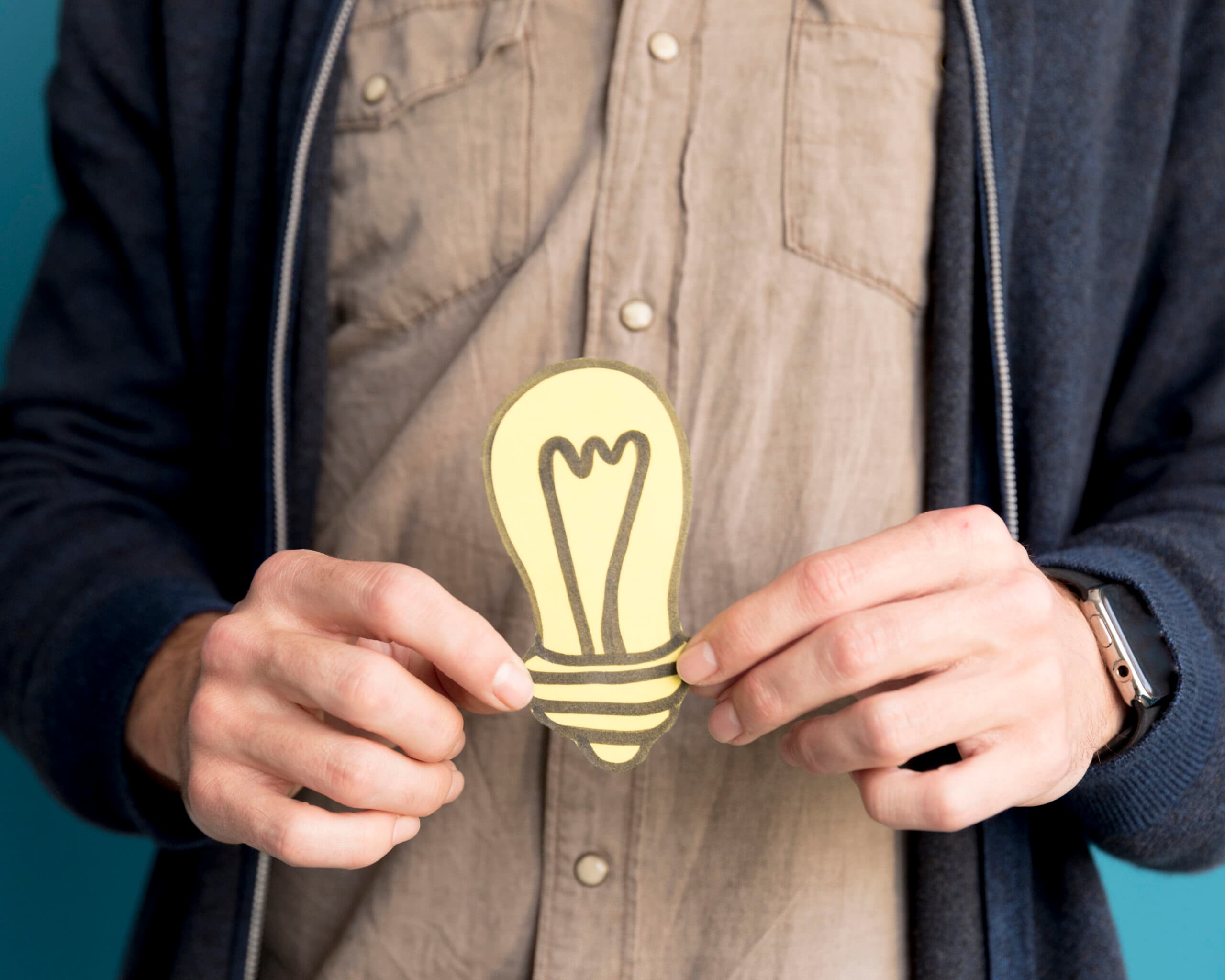 close-up-man-holding-idea-light-scaled