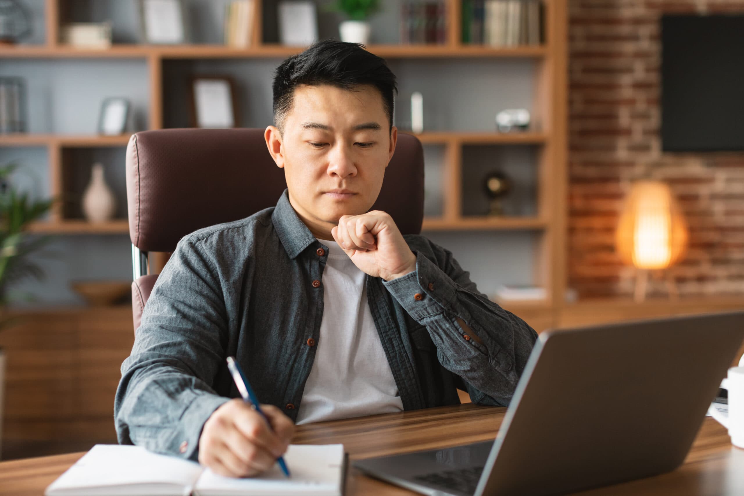 serious-concentrated-adult-asian-man-makes-notes-2025-03-18-16-17-46-utc-scaled